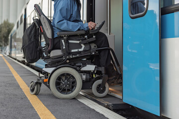 Man with disability on electric wheelchair entering a train. Accessible travel and inclusive transportation concepts.