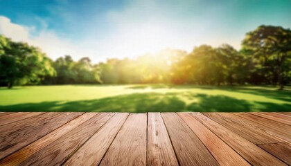 An empty wooden table on a wood terrace floor, with a stage-like setting and a blurred green park view, bathed in sunlight, creating a serene outdoor atmosphere.