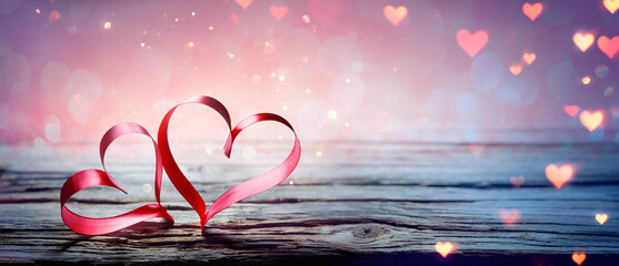 Valentine's Day - Two Ribbon Hearts With Magic Bokeh Lights On Wooden Table And Abstract Defocused...