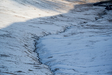 River Valley flowing from winter snow covered Mountain © CAylward