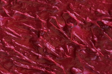 Red color lipstick textured background close up