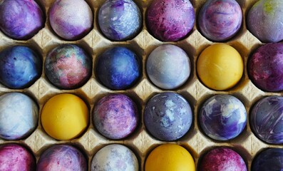 Easter eggs. Organized in a cardboard egg tray. Colorful, bright, handmade, decorated. Sustainable cardboard packaging