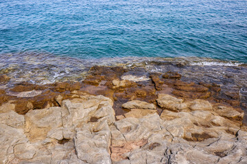 Adriatic Sea with Stony Shore in Pula. Rocks and Blue Water in Croatia. Summer Vacation Rocky Coast in Europe.