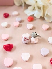 Diamond Engagement Ring with 'Marry Me' Conversation Heart Surrounded by Pastel Candy Hearts for Valentine's Day