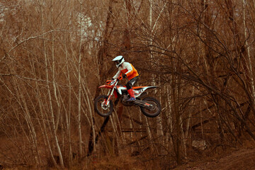 Motocross racer rides through the desert.