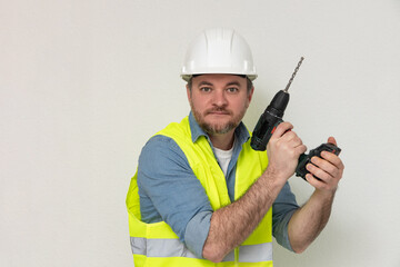 A construction worker wearing a white helmet and yellow vest holds a drill in a dynamic pose, expressing readiness, symbolizing skill and professionalism in construction tasks. free space