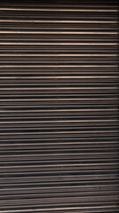 Texture of a metal shutter with lines and reflections