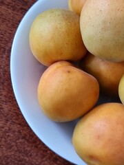 fresh yellow apricots on a wooden background