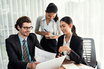 Diverse of business people from various ethnic group working in modern office environment. Productive and multi ethnic office workers engage in discussion for strategic business marketing. Meticulous