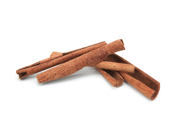 Cinnamon sticks in a heap scattered isolated on white background. Spices.