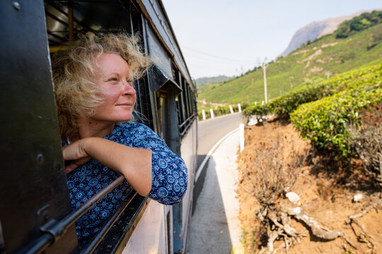 Female tourist having a bus ride from Munnar to Marayoor along tea plantations in Kerala, India