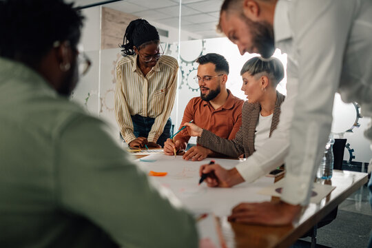 Businesspeople collaborating on project during office meeting