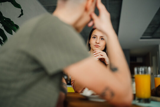 Lesbian couple having a serious conversation during breakfast at home