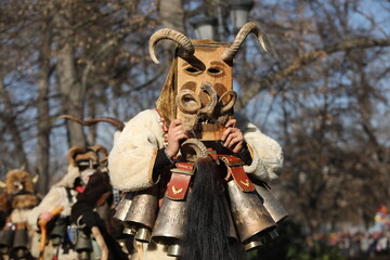 The Surva masquerade games festival in Sofia, Bulgaria. People called Kukeri parade in masks and...