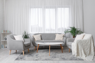 Interior of modern light living room with comfortable sofa