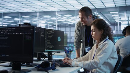 Woman requesting help from senior engineer to fix error in high tech AI data center. Employee in need of aid from IT professional to repair artificial intelligence supercomputers, camera B