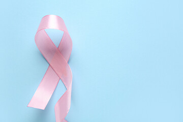 Pink ribbon on blue background. World Cancer Day
