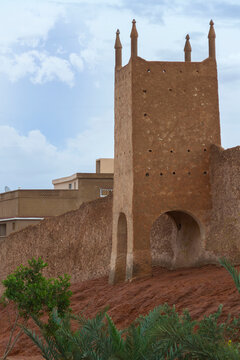 Traditional Mud-Brick Tower with Spires and Arched Openings