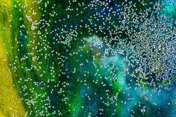 Abstract green and blue water background with bubbles and sparkles. abstract background with a color transition filled with numerous small bubbles. Creates a sense of depth, freshness and dynamics