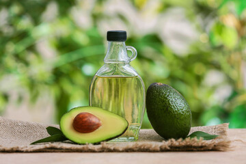 Bottle of avocado oil on table outdoors
