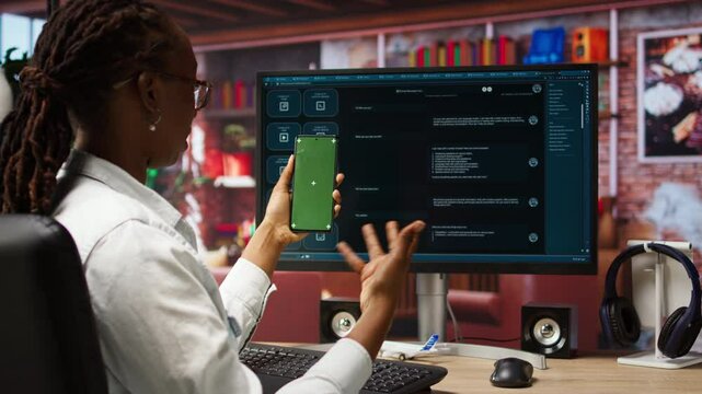 Woman at home holding mockup smartphone asks questions to AI LLM virtual assistant answering prompts. Person with chroma key phone receiving information from artificial intelligence GPT, camera A