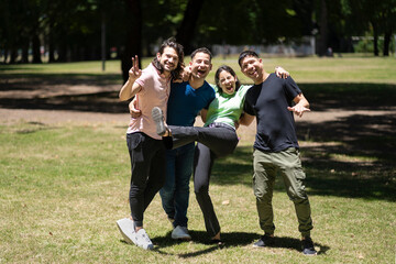 Fototapeta premium Group of latin friends in a park making a funny pose for the photo