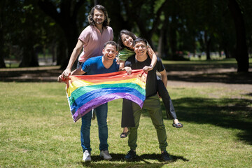 Fototapeta premium Group of latin friends holding the LGBT flag
