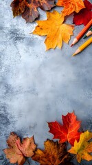 Autumn Leaves and Colored Pencils on Gray Background