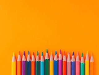 Color Pencils Arranged on Orange Background