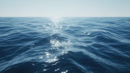 Fototapeta premium Tranquil ocean view with sunlit waves under clear blue sky