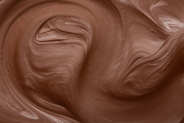 Creamy swirl of melted milk chocolate as background