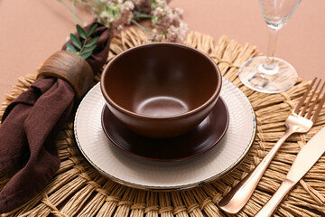 Beautiful table setting with gypsophila flowers and leaves on brown background