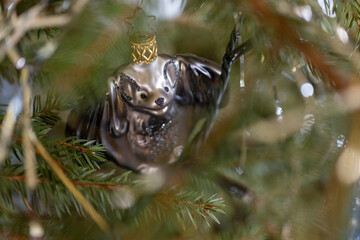Christmas glass ornament bat on a spruce.
