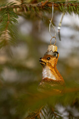 Christmas glass decoration of a fox on a spruce.
