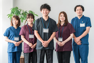 スクラブを着た医師・介護士・整体師の男女
