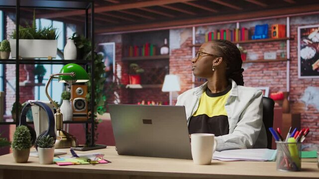 Fatigued woman daydreaming, gazing outside the window, feeling bored after working too much on job tasks. Contemplative person at home caught in thoughts, pondering, camera A