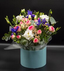 Bouquet of different beautiful flowers on a gray background. Background with flowers for design.