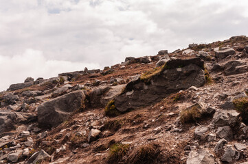 A rocky hillside with a few small rocks scattered around
