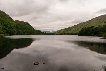 A lake with a cloudy sky in the background