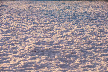 A snow covered field with a light pinkish hue
