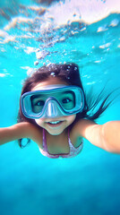 Naklejka premium Young Girl Swims Underwater with Goggles Smiling in Clear Blue Water Joyfully
