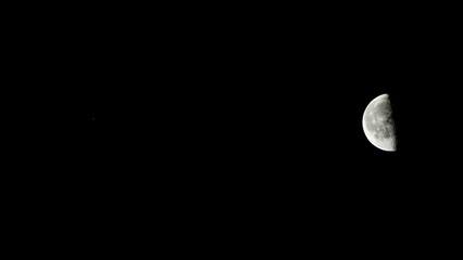 The moon in the night sky, closeup of a half moon © Champ