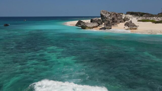 Aerial view of the white sand beach, the clear water of the Indian Ocean and a fishing boat. Rote island. Sumba island. Indonesia