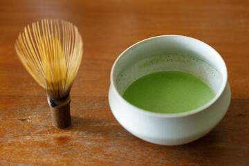 Cup of fresh matcha tea, green tea on wooden table