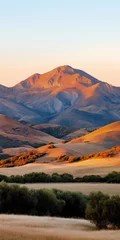 Golden hour mountain landscape with warm sunlight illuminating rolling hills and natural beauty for mobile wallpaper