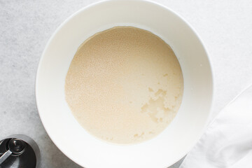 Overhead view of Hydrated instant dry yeast, top view of instant dry yeast dissolved in warm water
