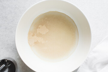 Overhead view of Hydrated instant dry yeast, top view of instant dry yeast dissolved in warm water