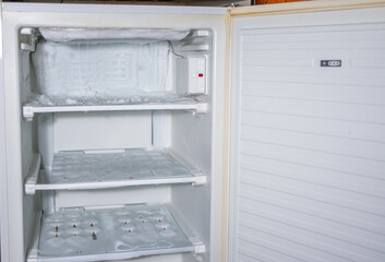 an ice crust has formed on the walls of the freezer and on the cooling tubes, and the ice is...