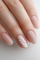 Close-up of elegant nude manicure with white leaf nail art on natural short nails, showcasing minimalistic nail design.