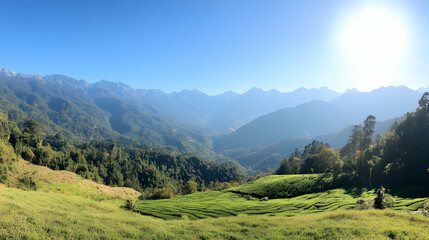 Fototapeta premium Panoramic view of sunlit mountain valley, terraced fields, and distant peaks; ideal for travel brochures